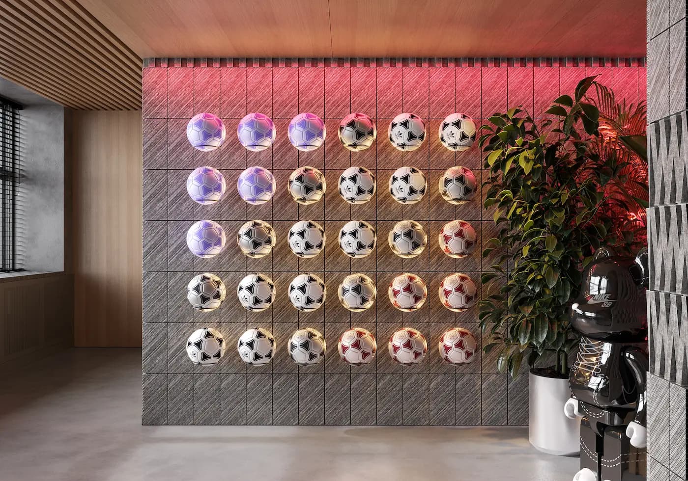 Custom wall installation displaying footballs in the BARÇA Mobile office
