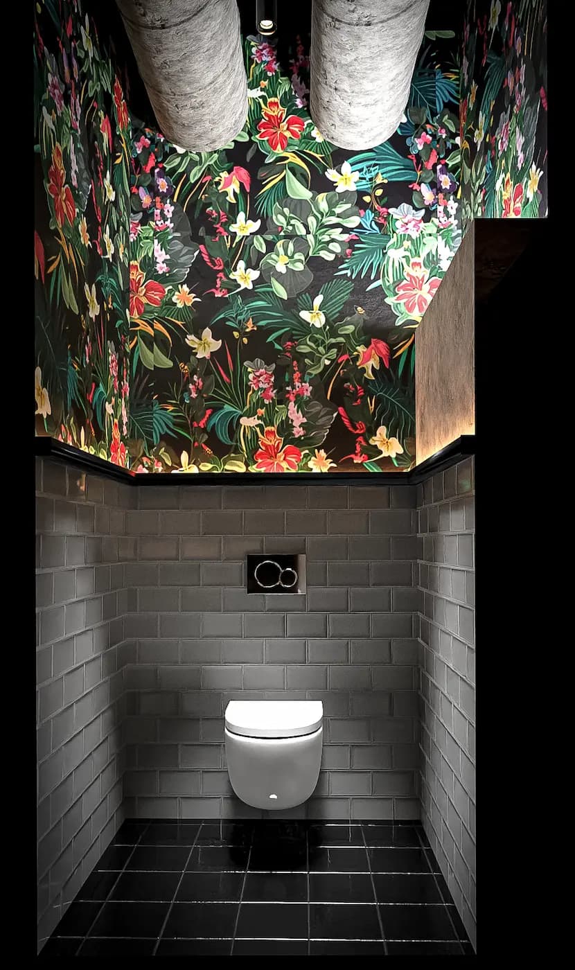 Private restroom area beneath a colorful patterned ceiling