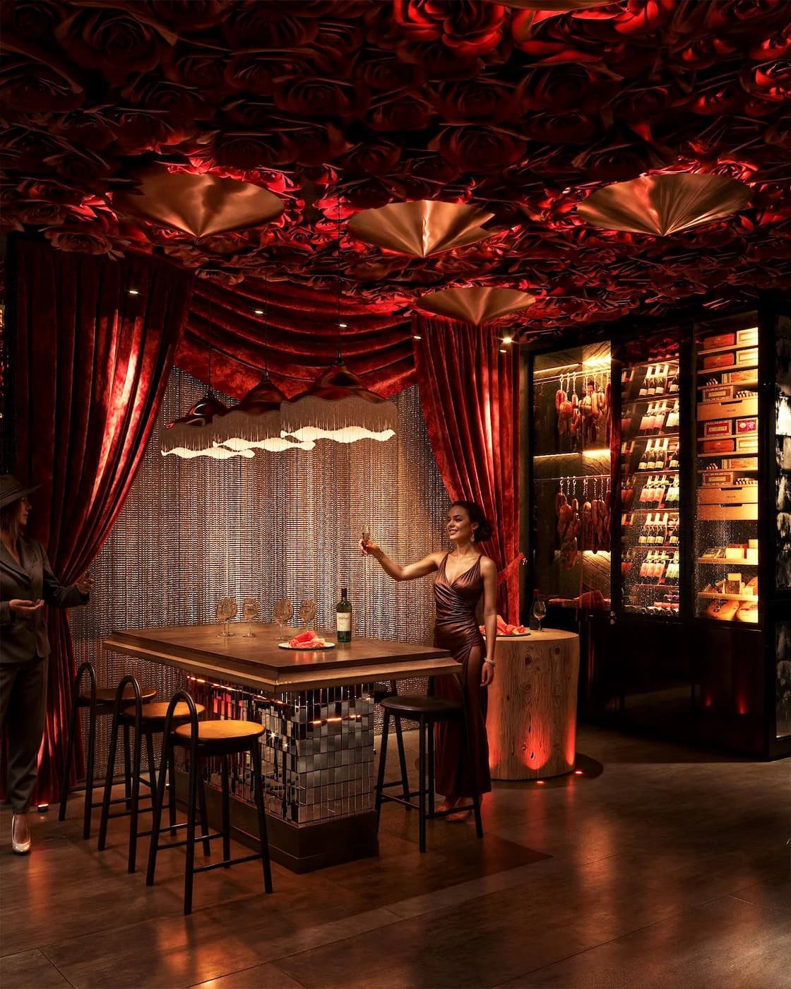 Private dining zone with patterned wall panels, warm lighting and richly detailed furniture