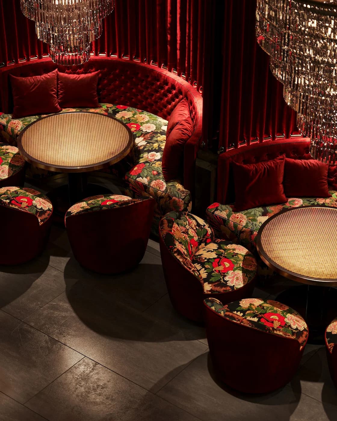 Luxury Havana lounge with floral seating, sculptural chandelier and saturated red accents