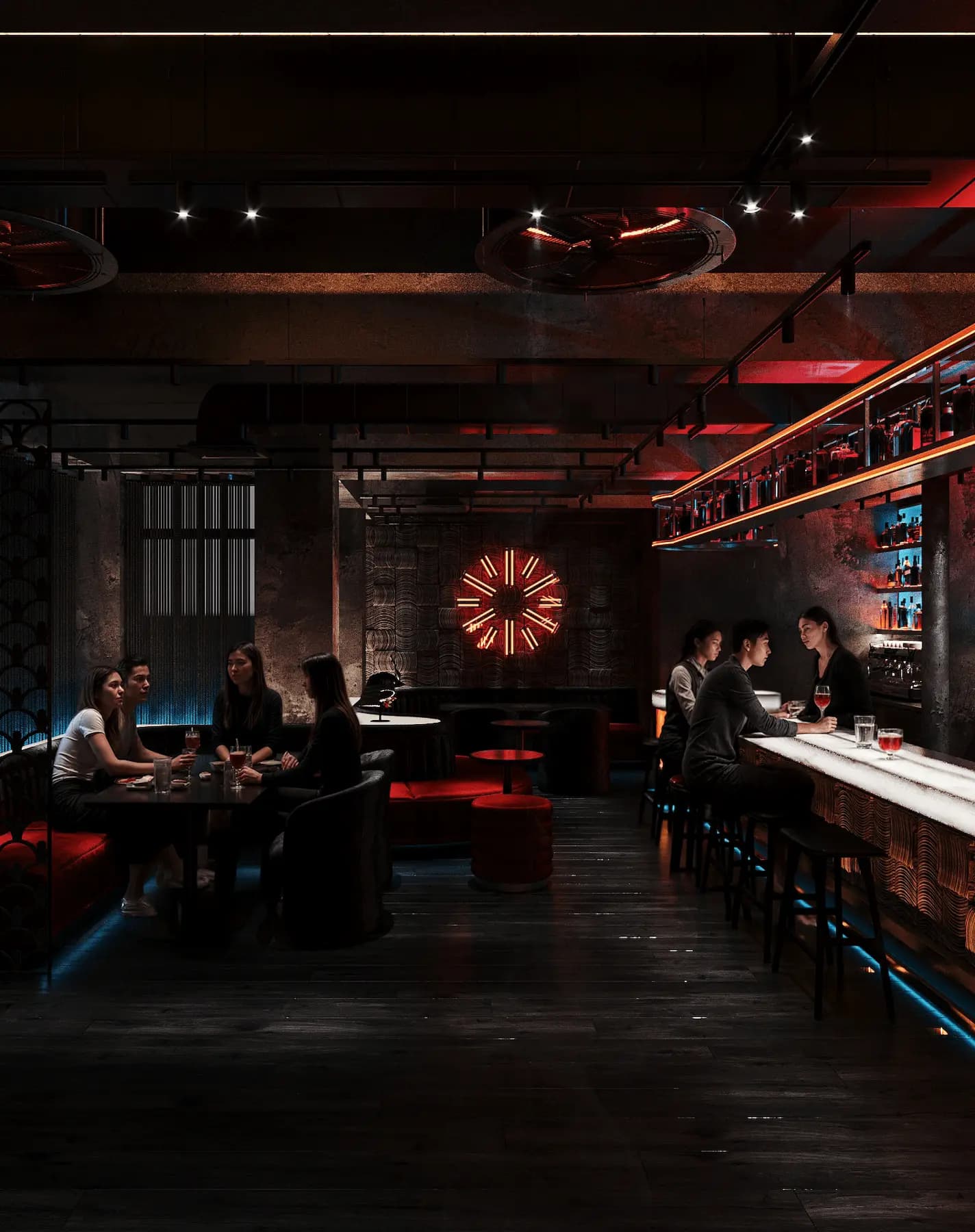 Restaurant interior with illuminated back bar and marble finishes