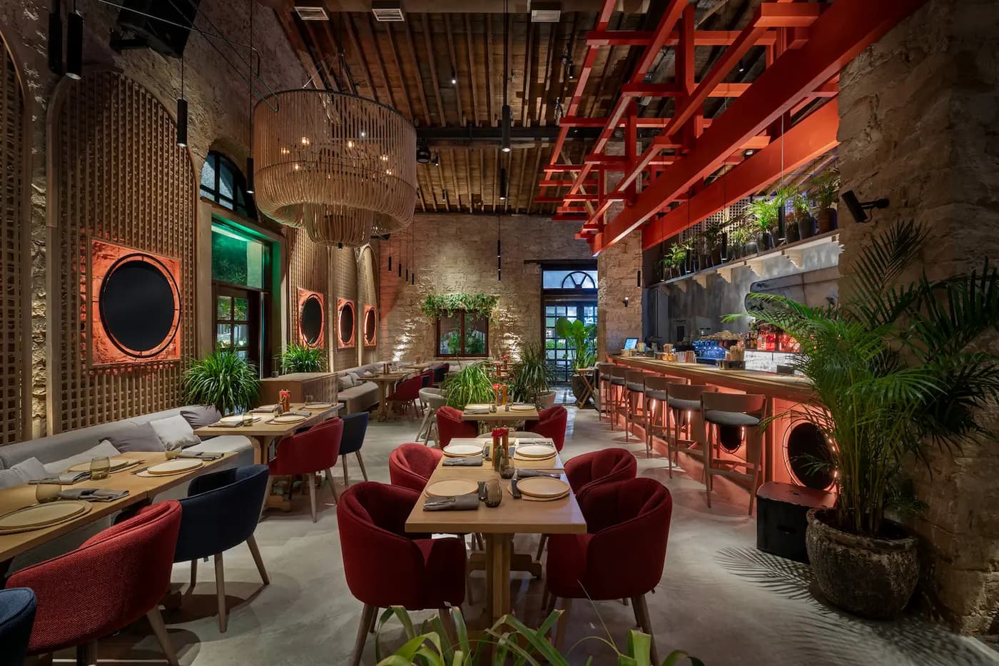 Lila Izakaya restaurant interior in Limassol with burgundy seating and sculptural lighting