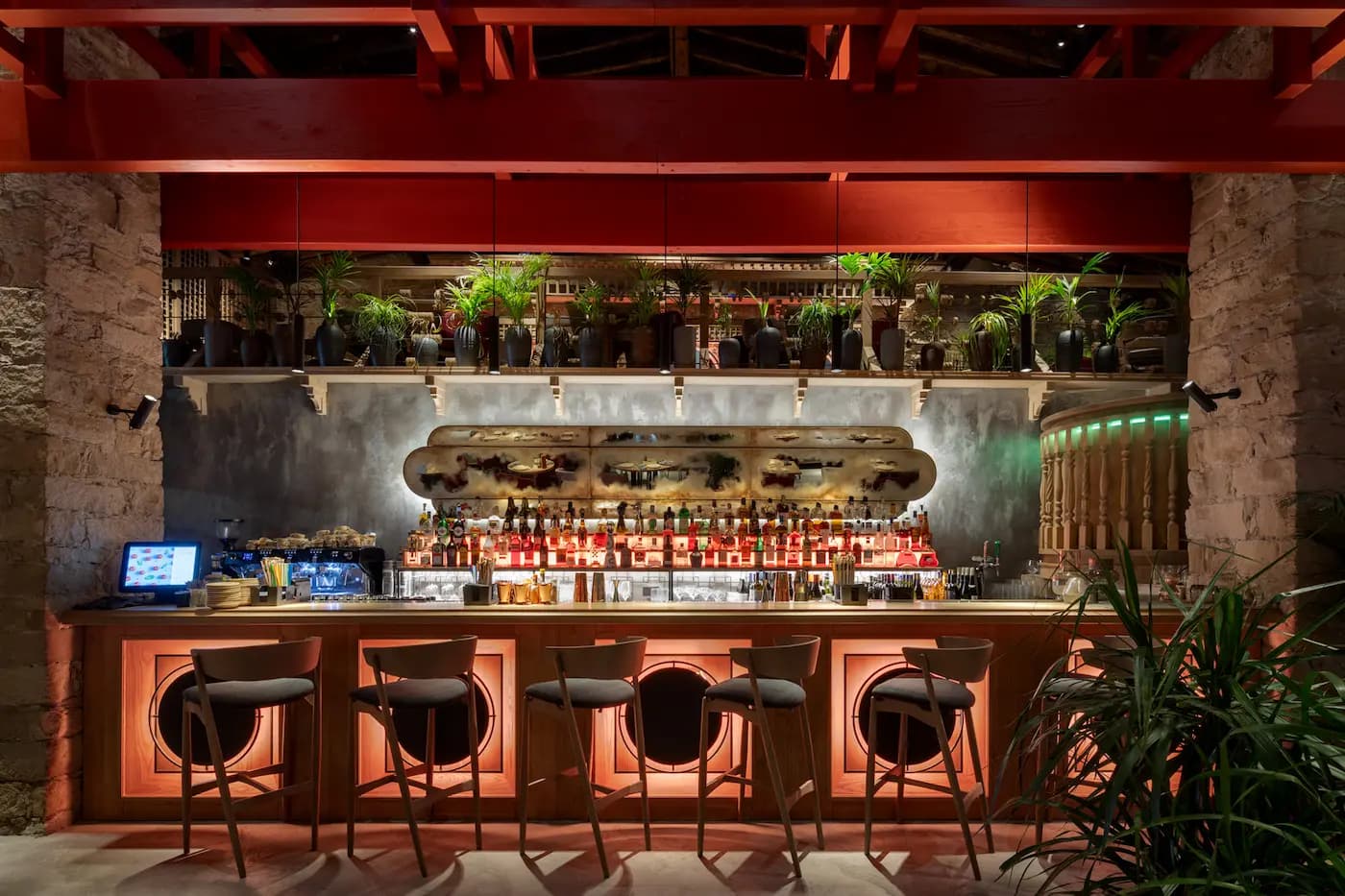 Lila Izakaya bar interior with warm timber, burgundy details and illuminated shelving