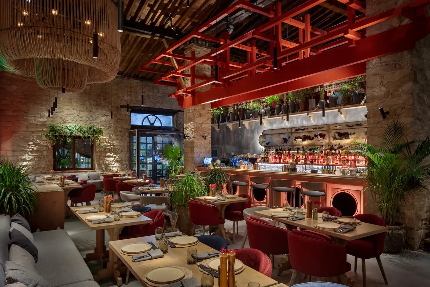 Lila Izakaya restaurant interior in Limassol with burgundy tones, natural stone and sculptural lighting