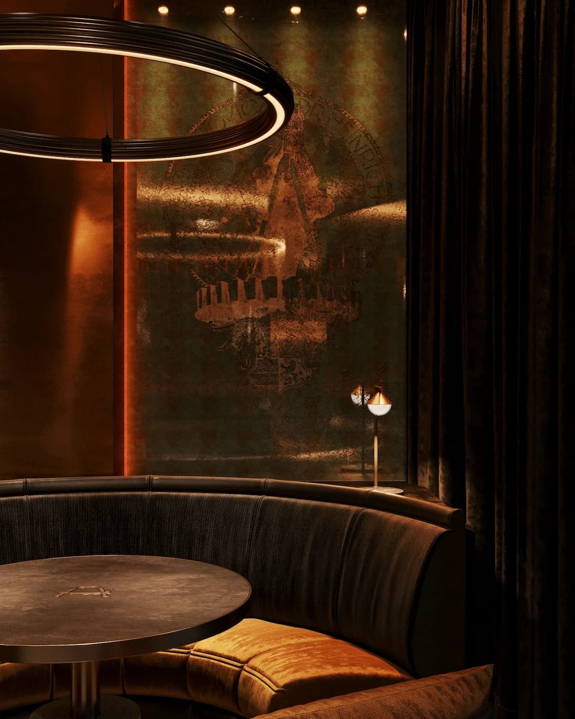 Intimate curved booth enclosed by bronze-toned glass and warm lighting