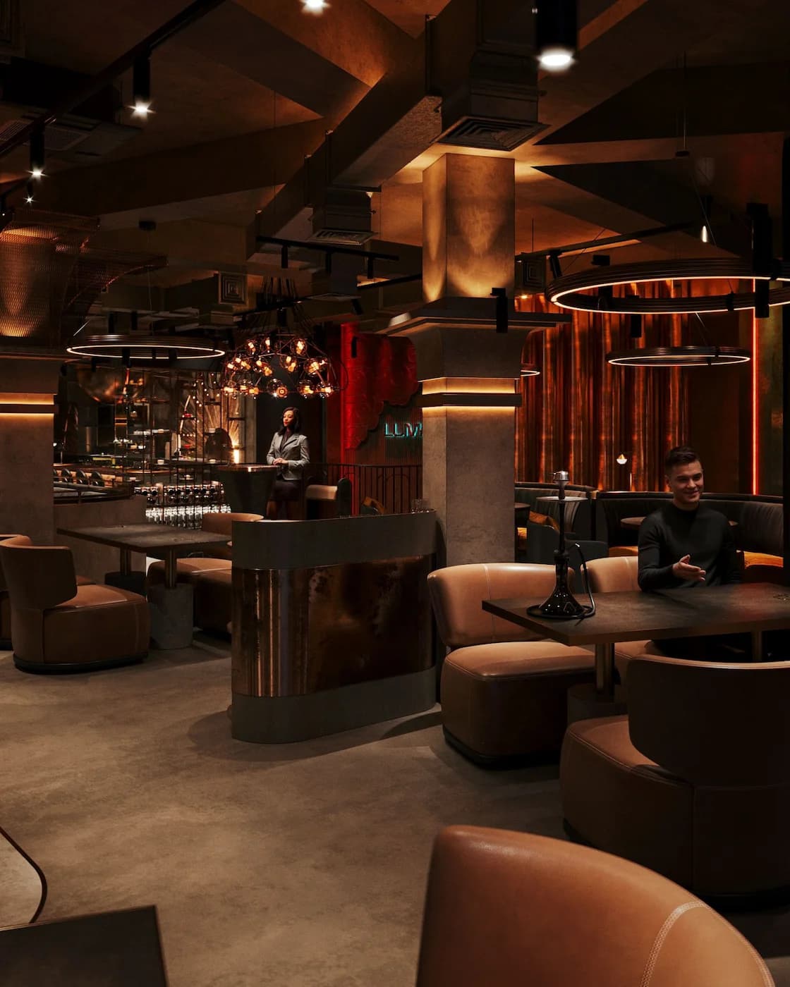 Central Luman lounge with sculptural lighting and curved upholstered seating