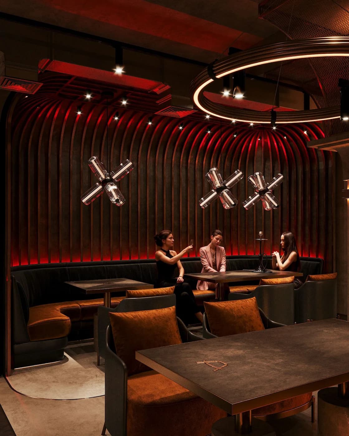 Private dining booth with circular pendant light and symbolic wall details