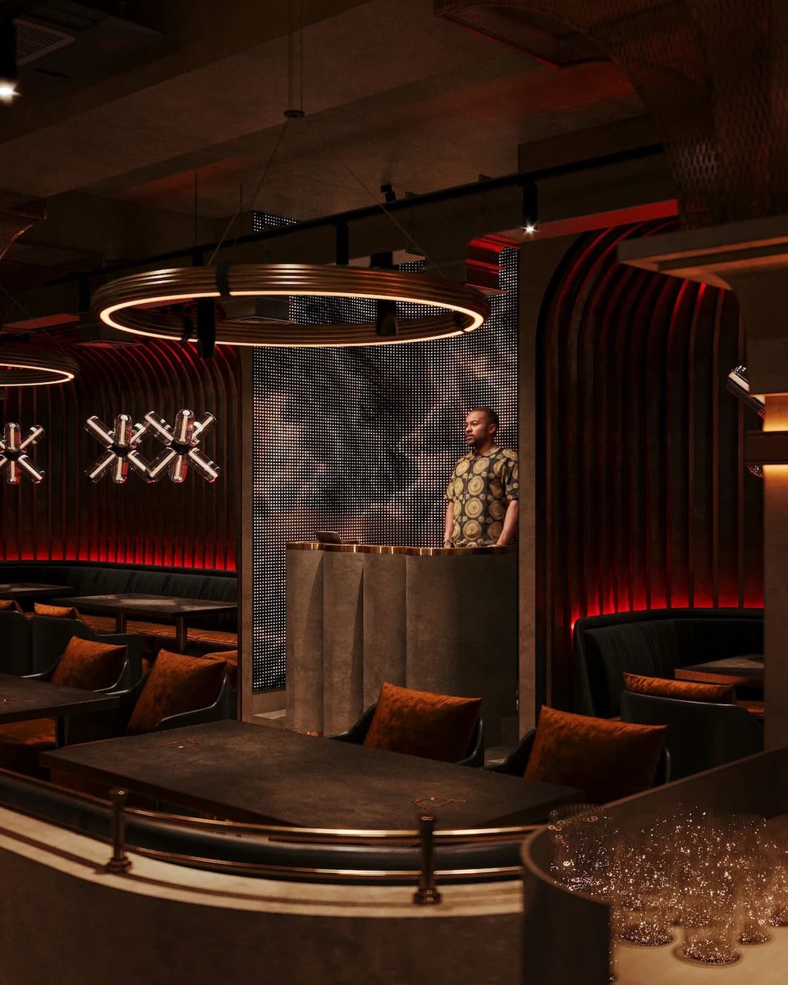 Curved lounge platform with theatrical lighting and dark upholstered seating