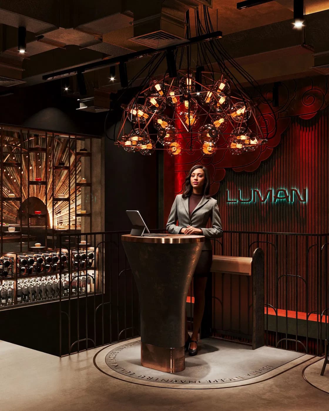 Luman reception area with sculptural chandelier and curved entrance podium