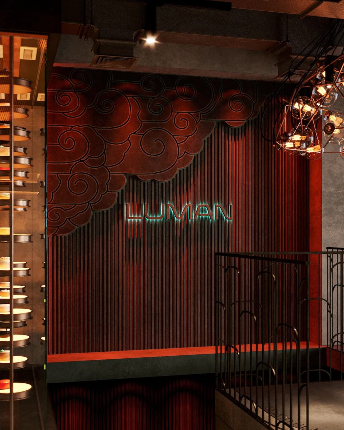 Concealed Luman entrance with red screens, illuminated logo and ornamental details