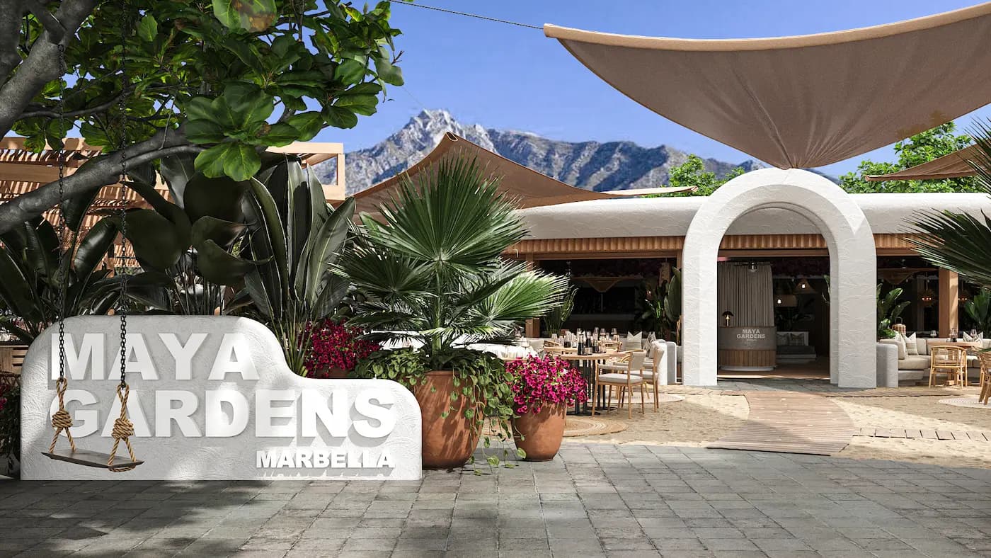Entrance to Maya Garden Marbella framed by white textured arches and tropical planting