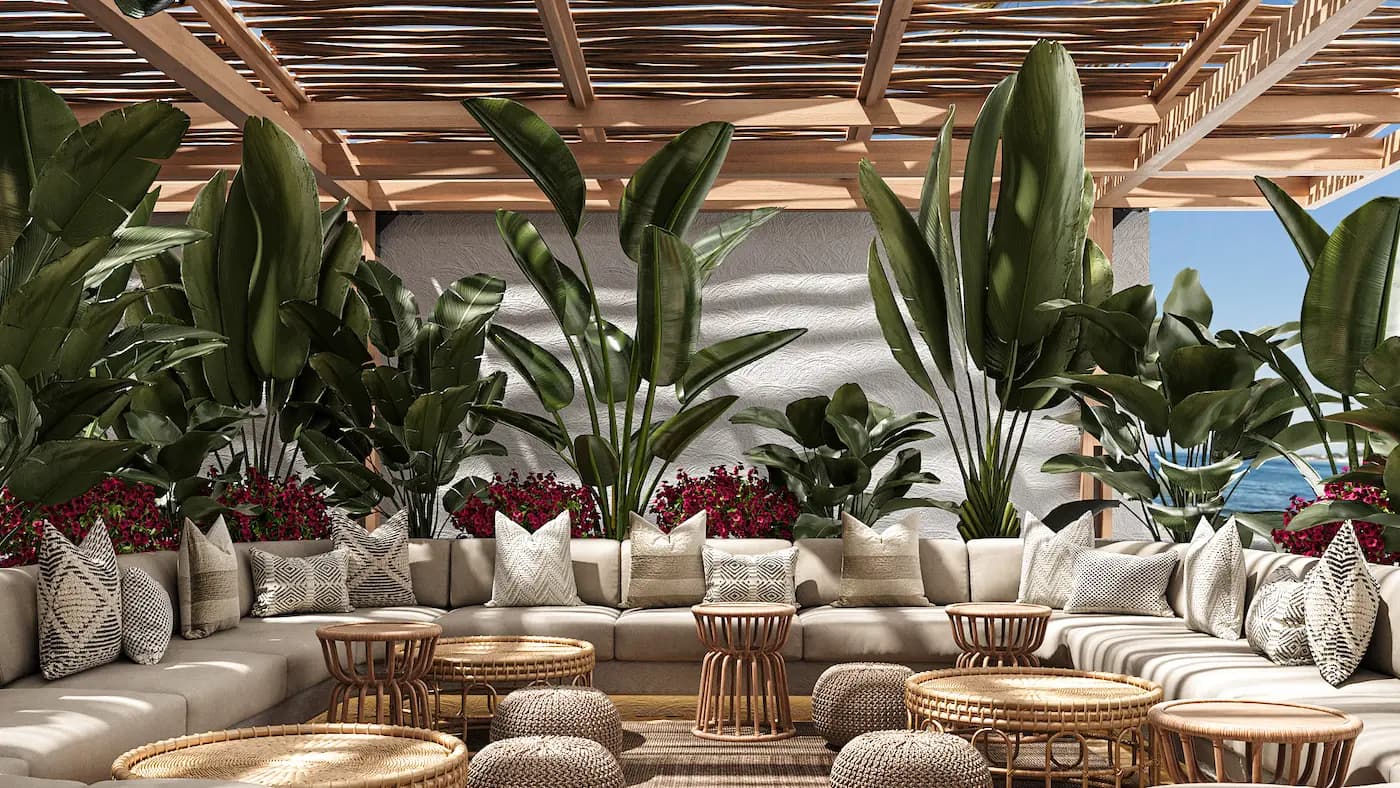 Restaurant seating surrounded by tropical plants and natural textured furniture