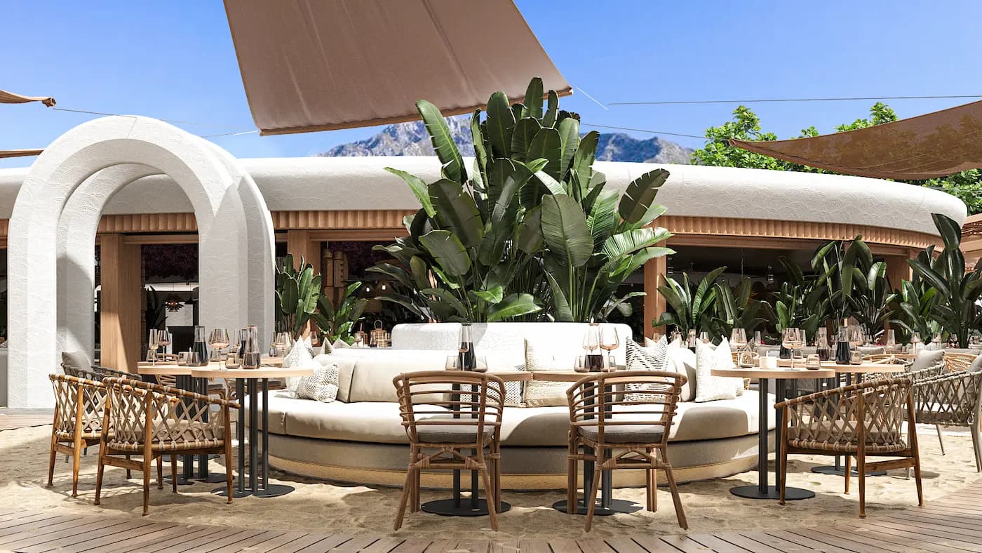 Exterior restaurant terrace framed by curved white architecture and greenery