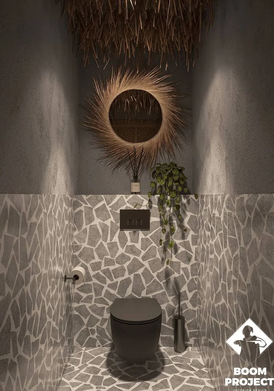 Restroom vanity with floral textured plaster, circular illuminated mirror and small stone basin