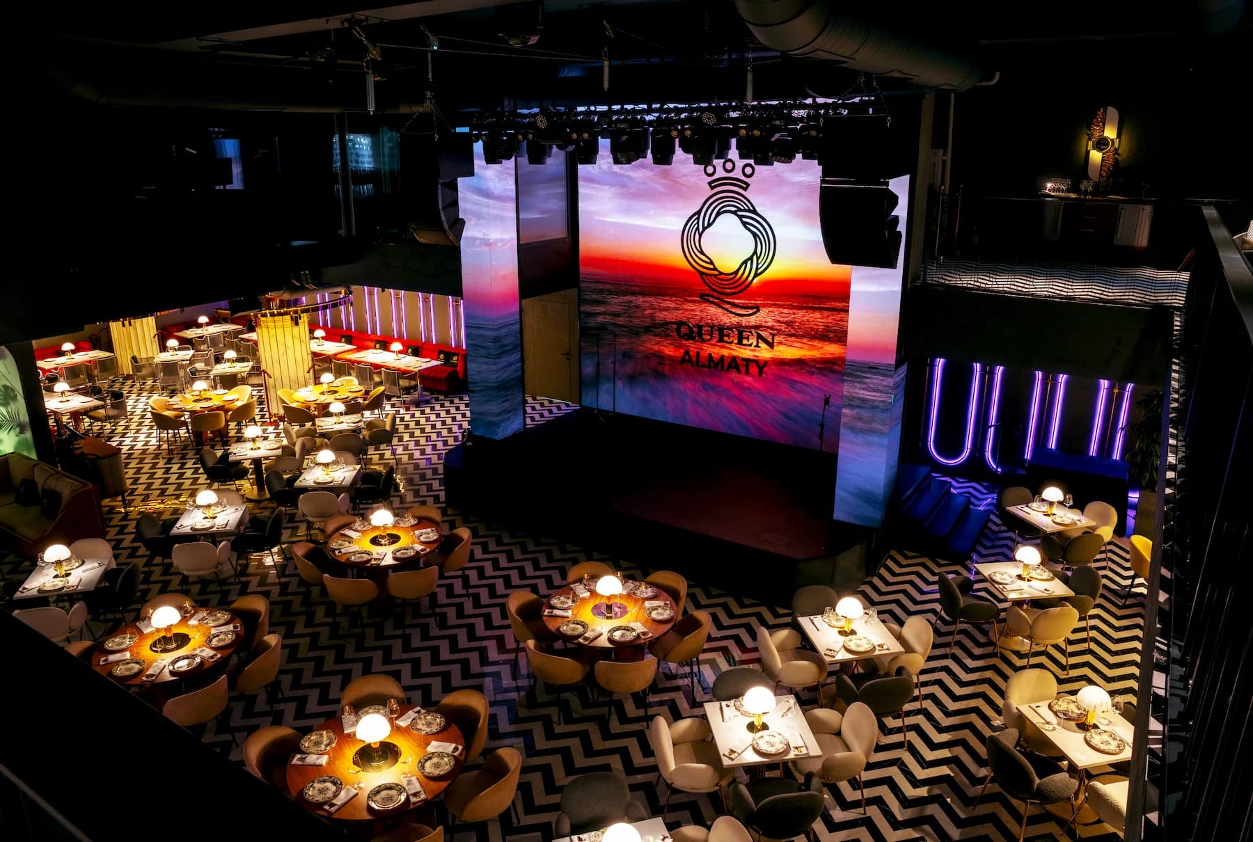 Overhead view of the Queen ballroom with round dining tables and graphic flooring
