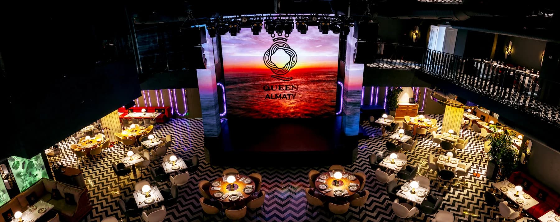Ballroom interior with sculptural chandeliers, patterned floor and multimedia screen