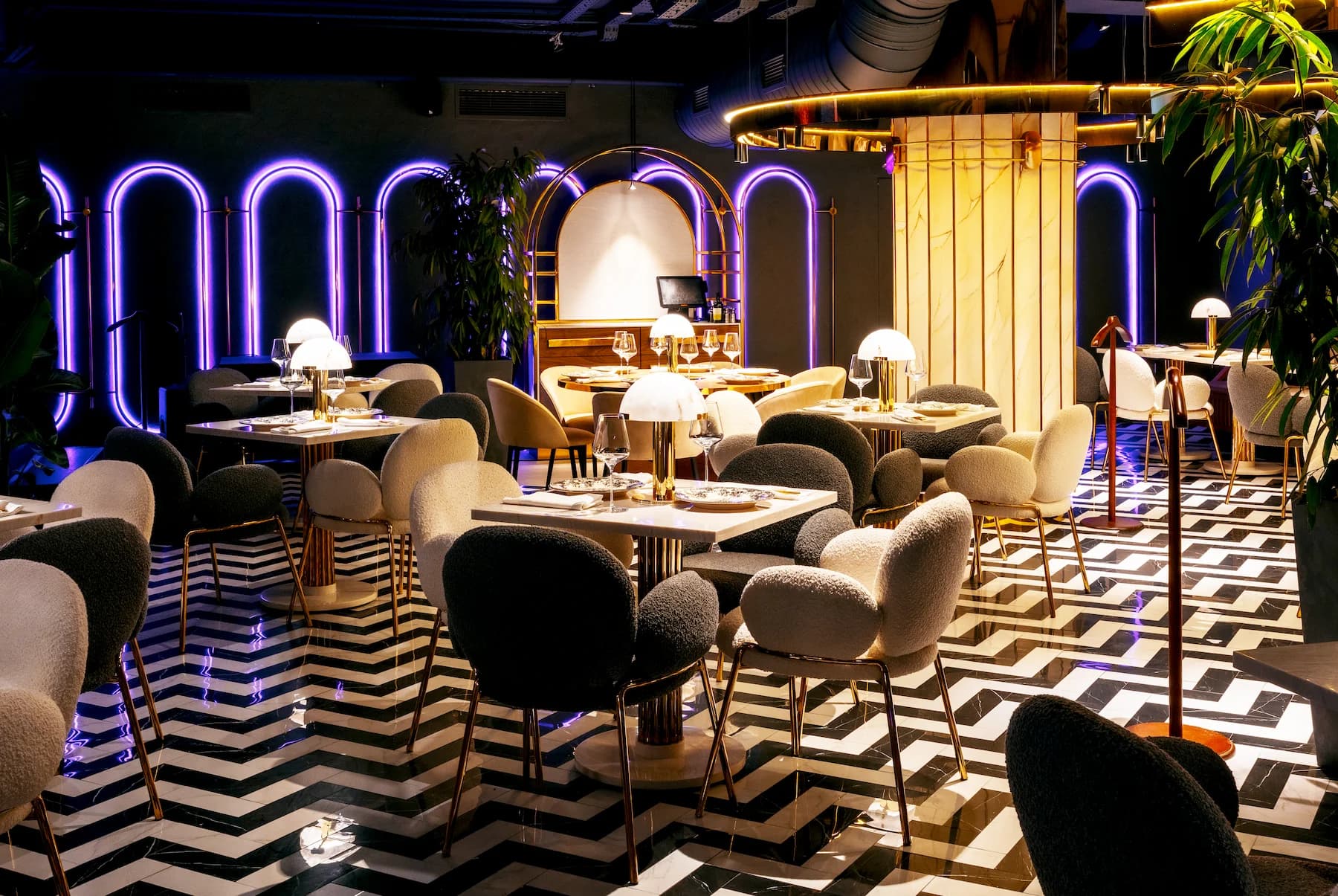 Elegant Queen dining room with upholstered chairs and illuminated decorative arches