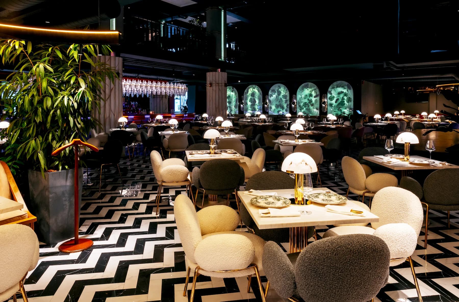 Elegant Queen dining area with circular arches and sculptural pendant lights