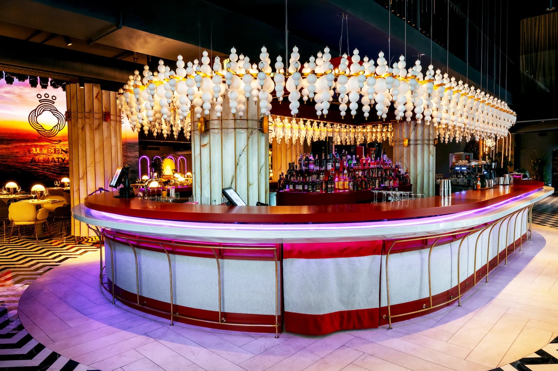 Ballroom interior with illuminated stage and sculptural hanging installation