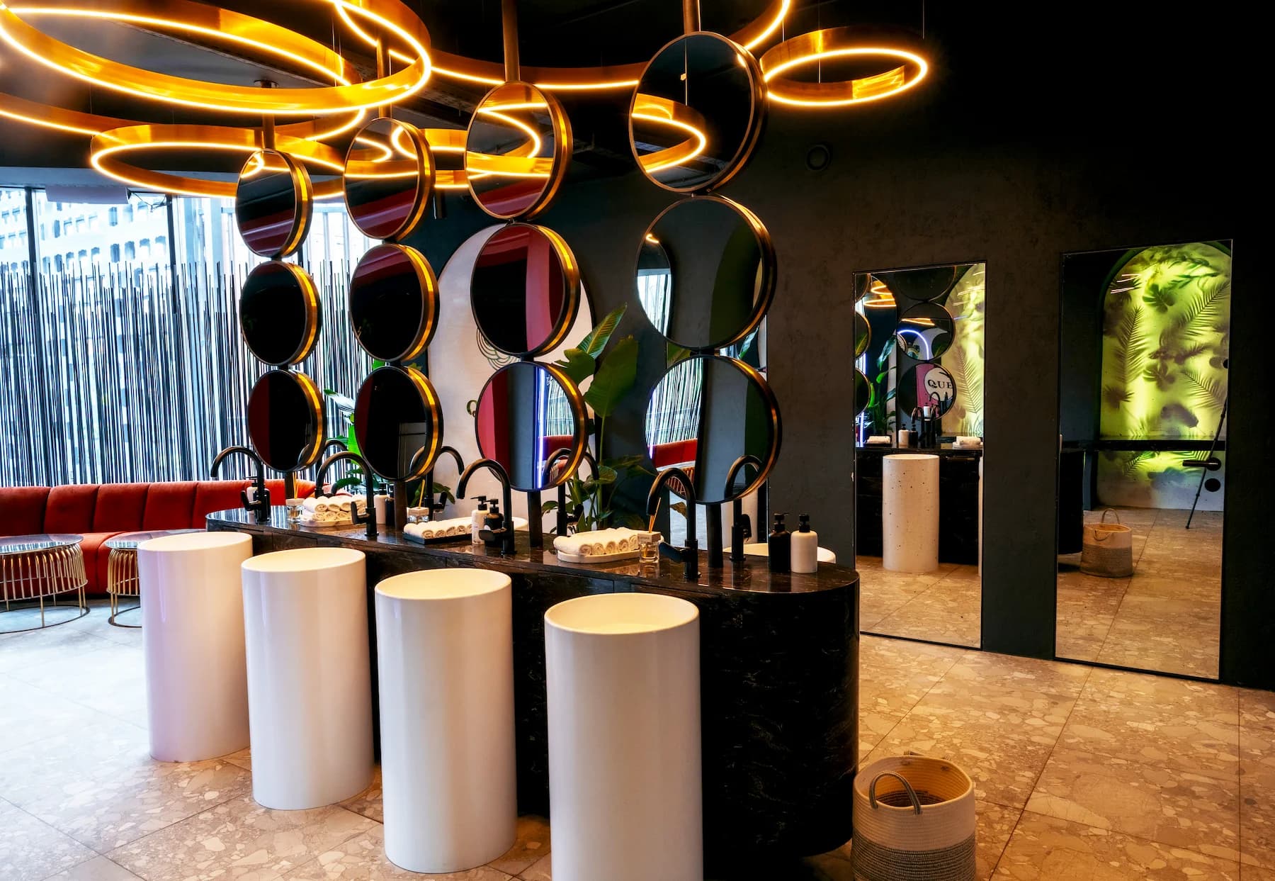 Curved Queen bar with suspended bottle installation and illuminated stone counter