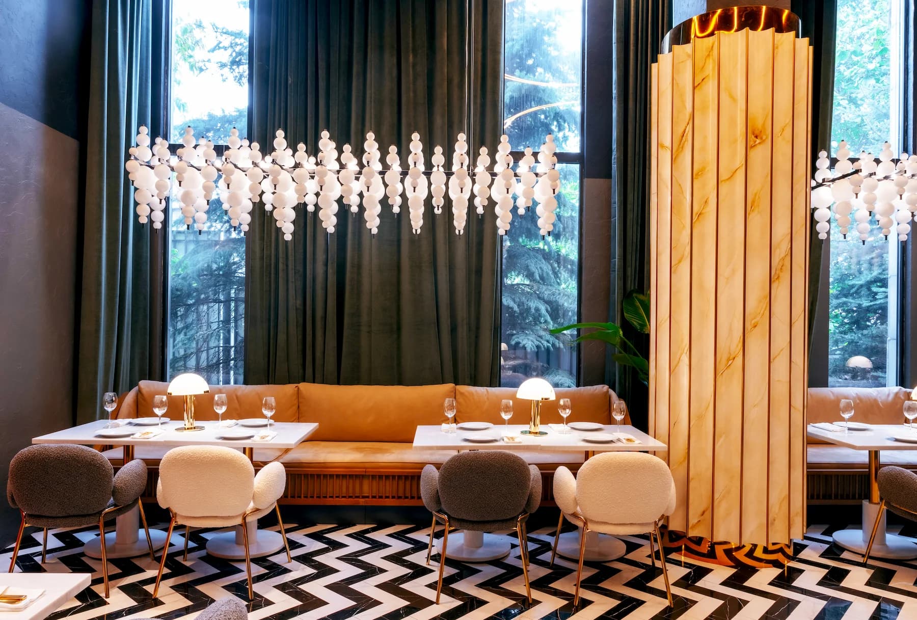 Reception area with illuminated circular ceiling elements and cylindrical podiums