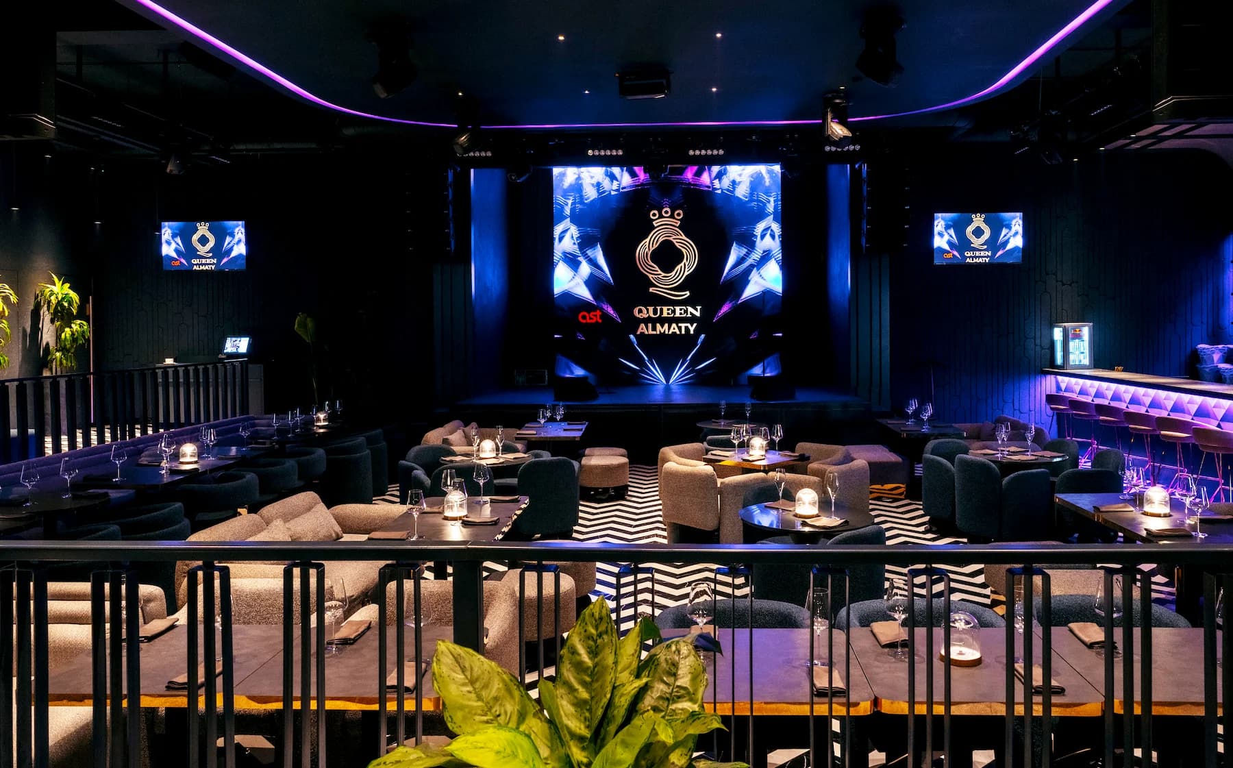 Queen entertainment hall with stage, graphic flooring and flexible seating