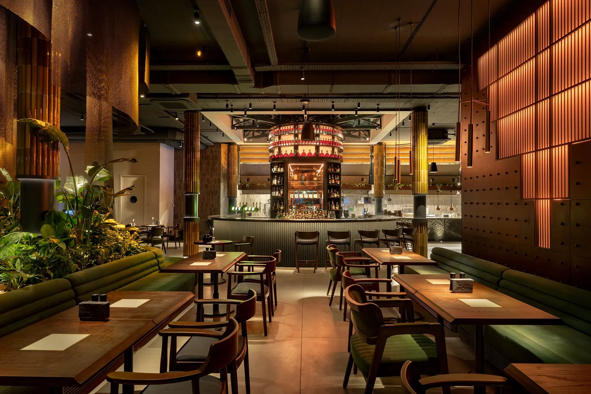 Restaurant seating beneath sculptural pendant lights