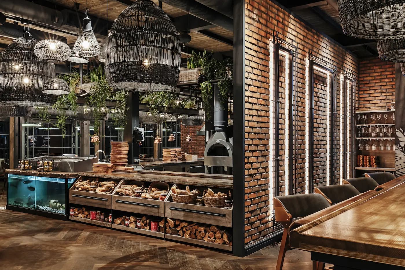 Side view of the service counter framed by illuminated bottle shelving and textured brickwork.