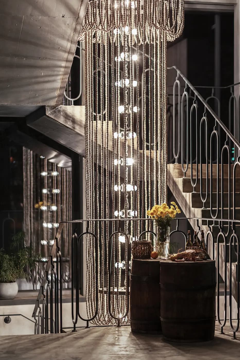 Close-up of a vertical glass lighting installation beside the restaurant staircase.