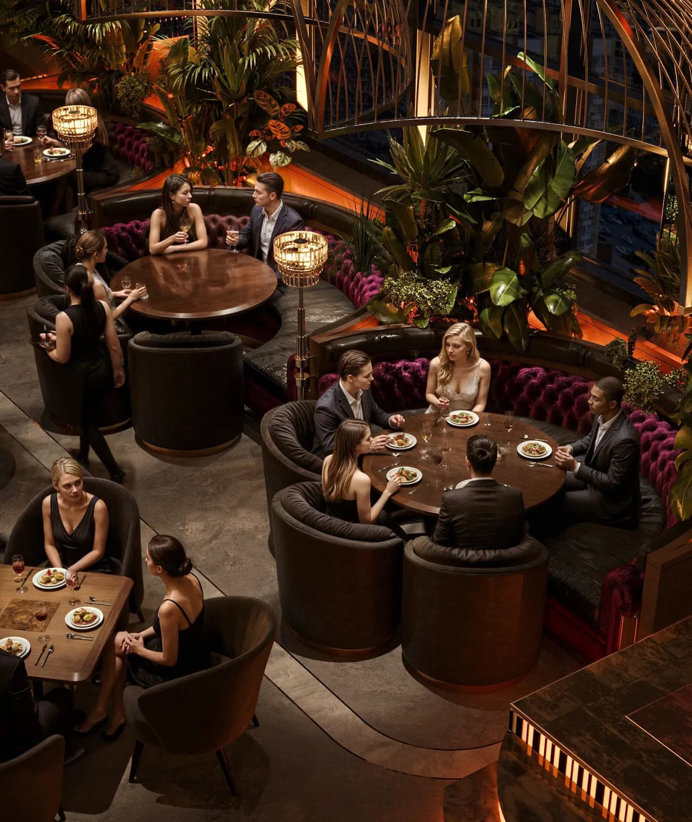 Overhead view of round booth tables and greenery accents in the Zaxi Restaurant dining hall