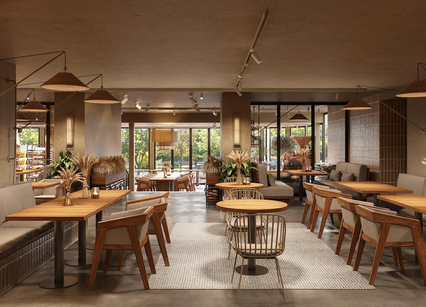 Cafe seating area with textured stone surfaces, custom tables and warm pendant lights