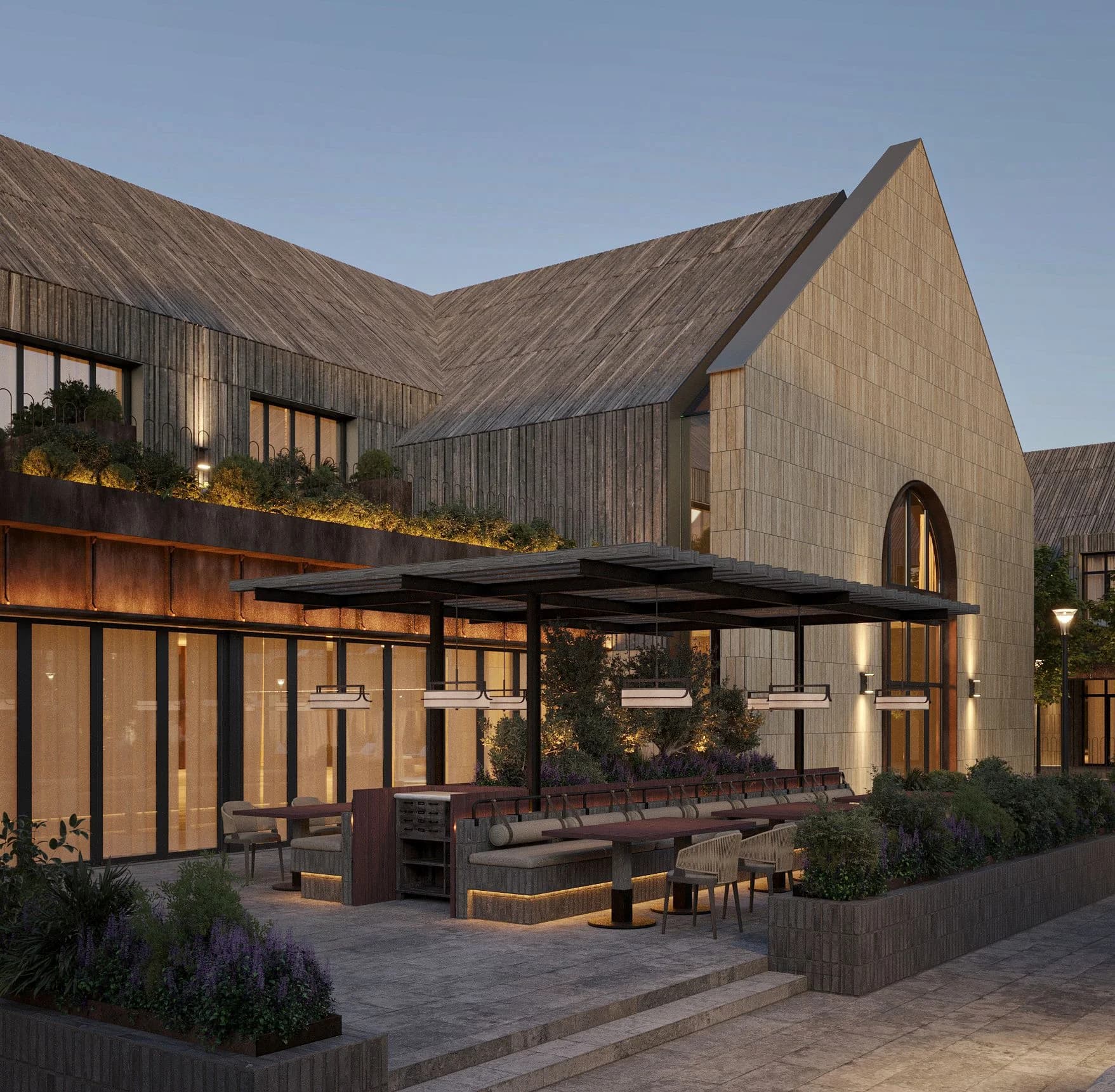 Terrace of the Shampan winery with a wooden pergola and outdoor furniture at dusk