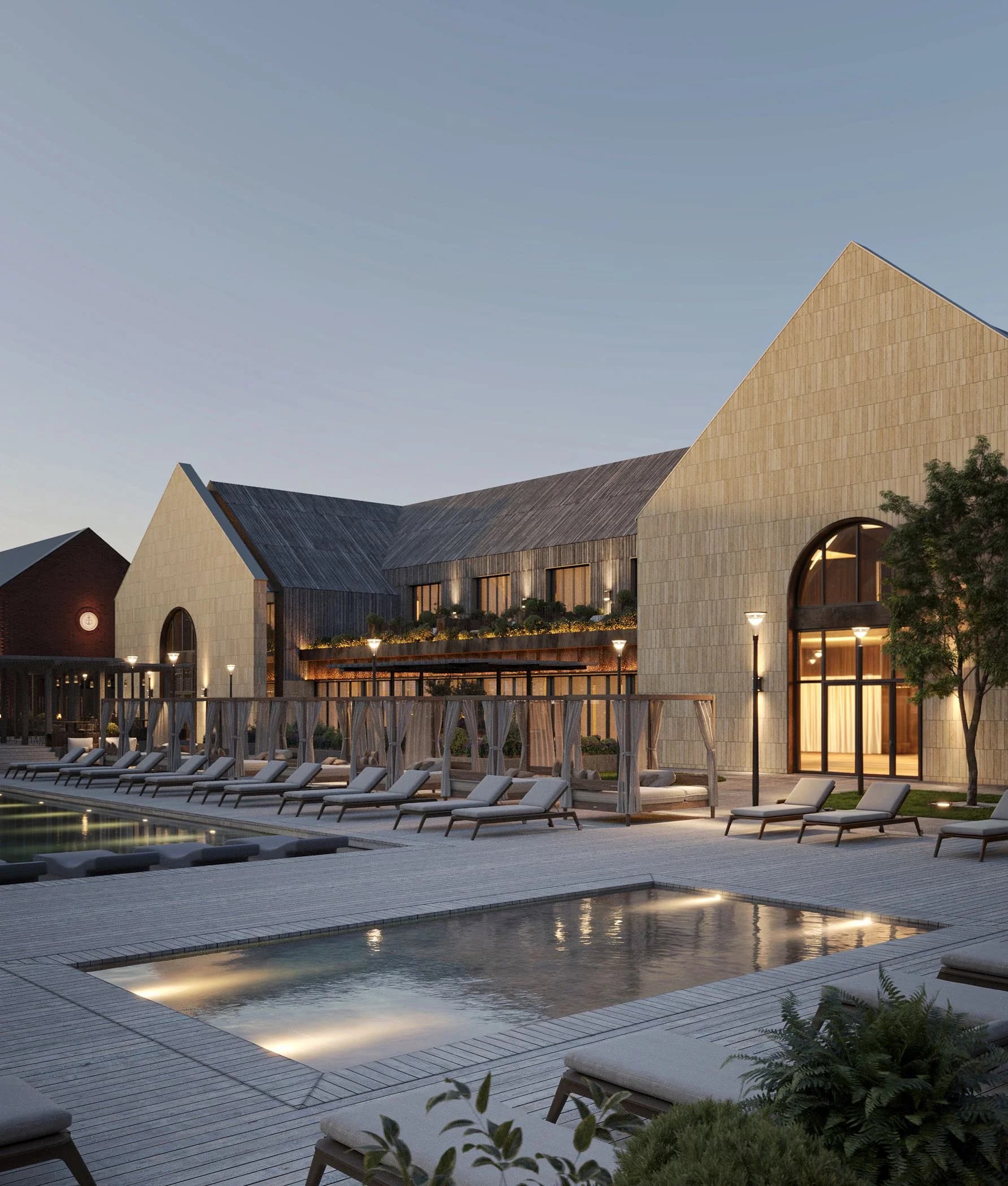 Panoramic view of the courtyard pool surrounded by gable-roofed stone buildings