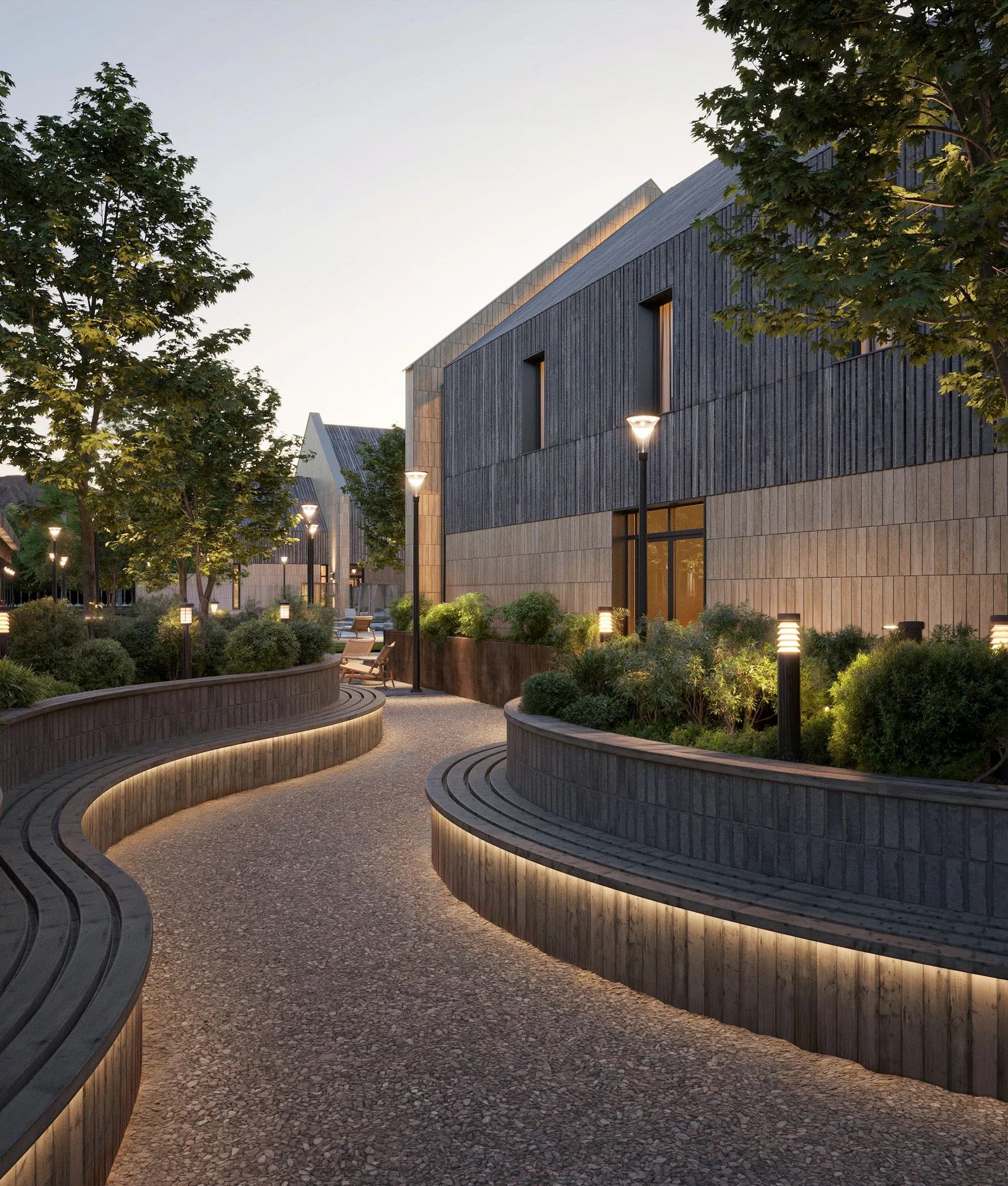 Curved path with wall lighting and landscaped planting in the evening
