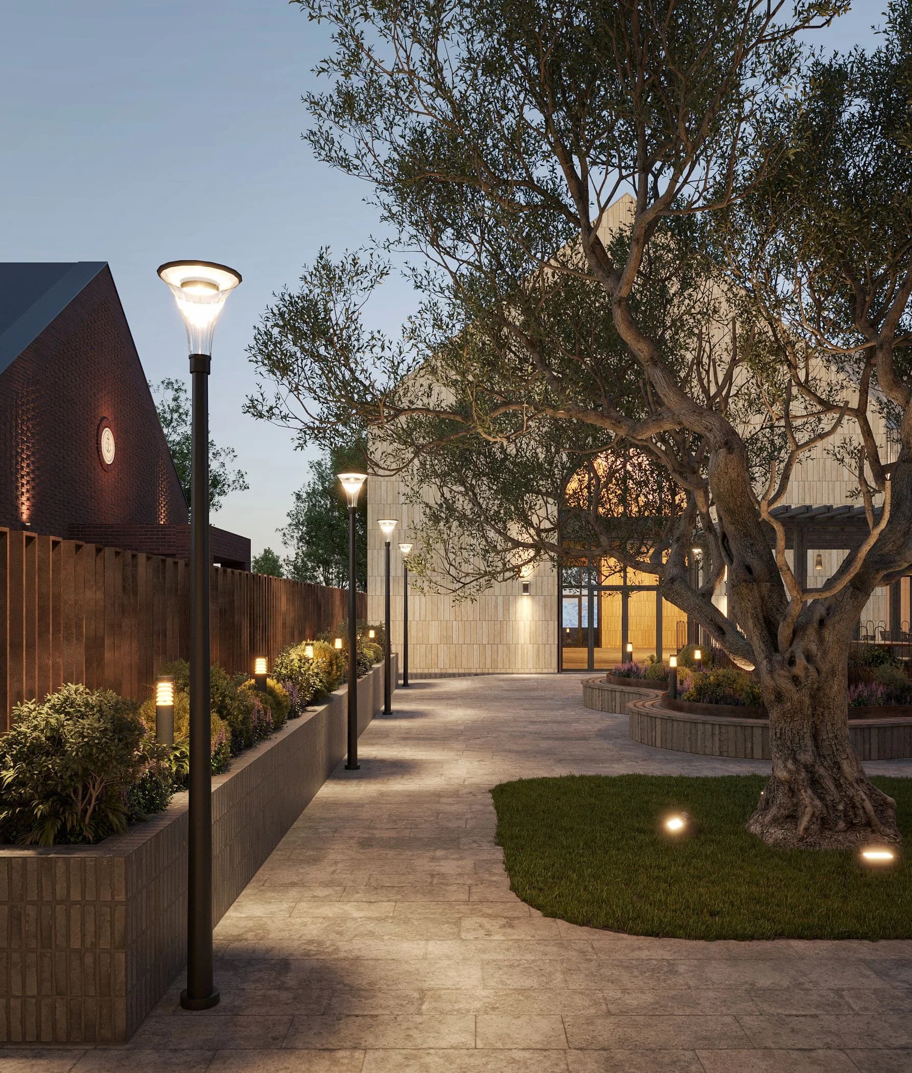 Pedestrian path with lamp posts and a tree amid evening landscaping