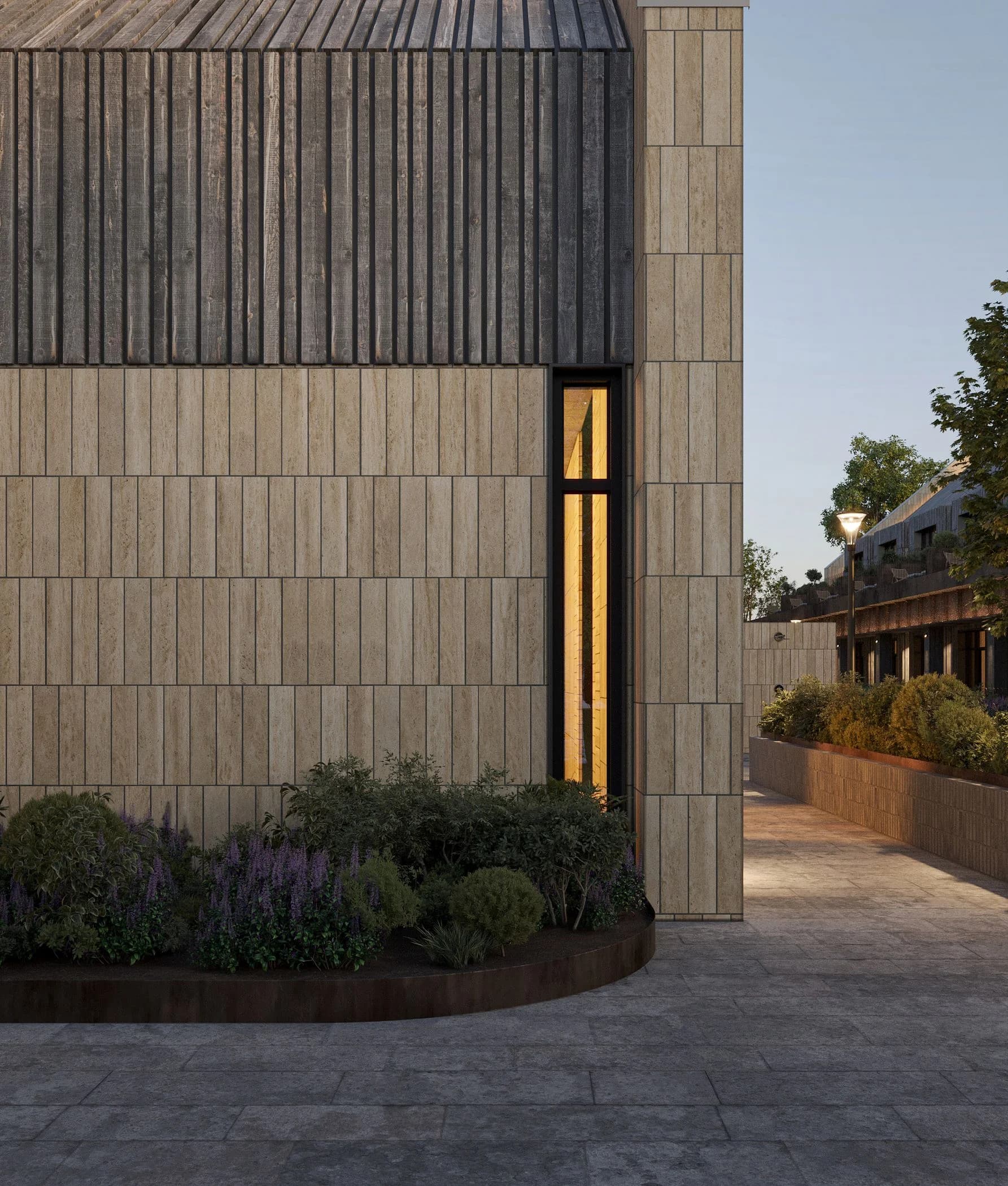 Close-up of a stone facade corner with a narrow window and entrance lighting