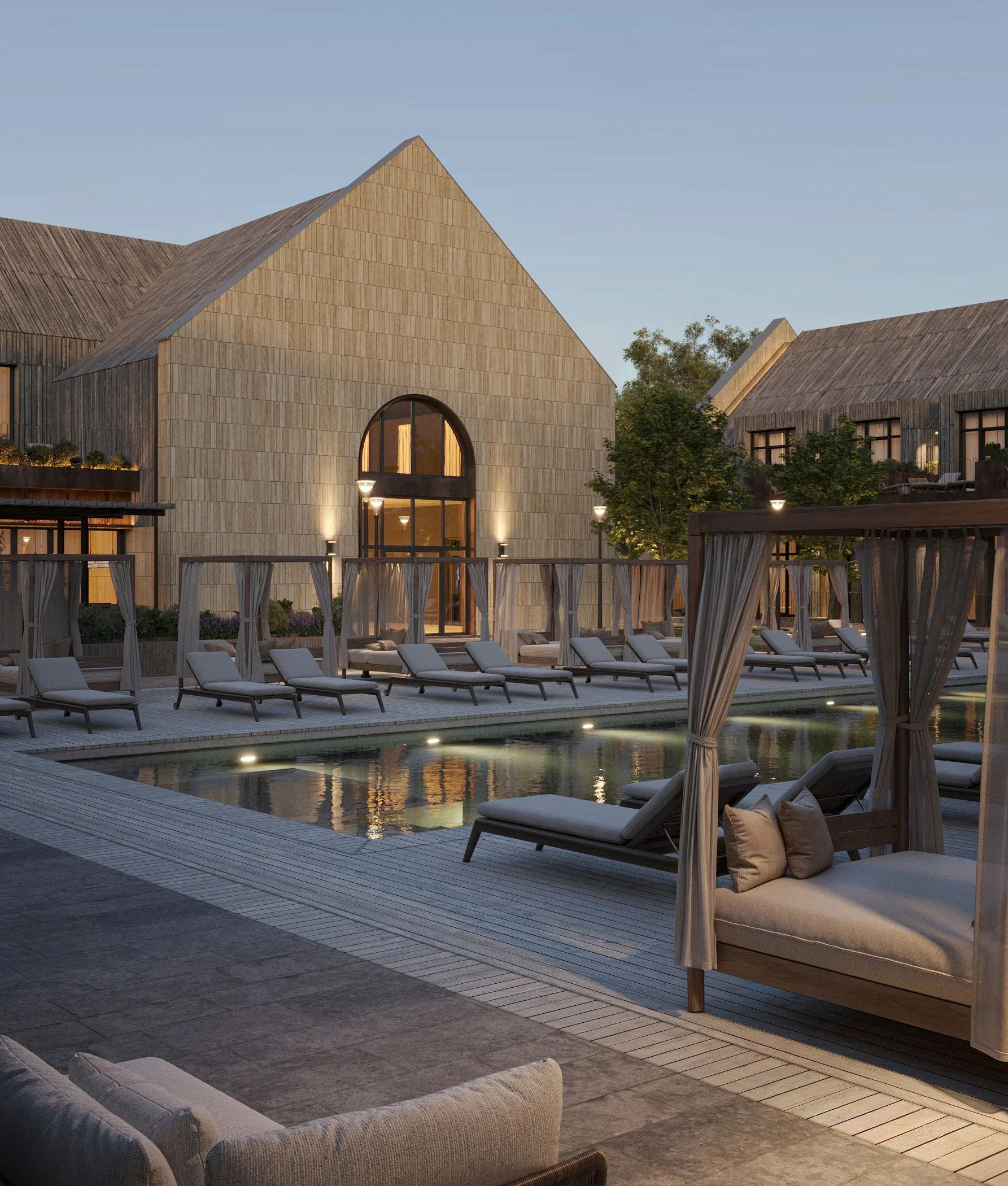 Poolside daybed lounge area against the stone facade of the Shampan winery