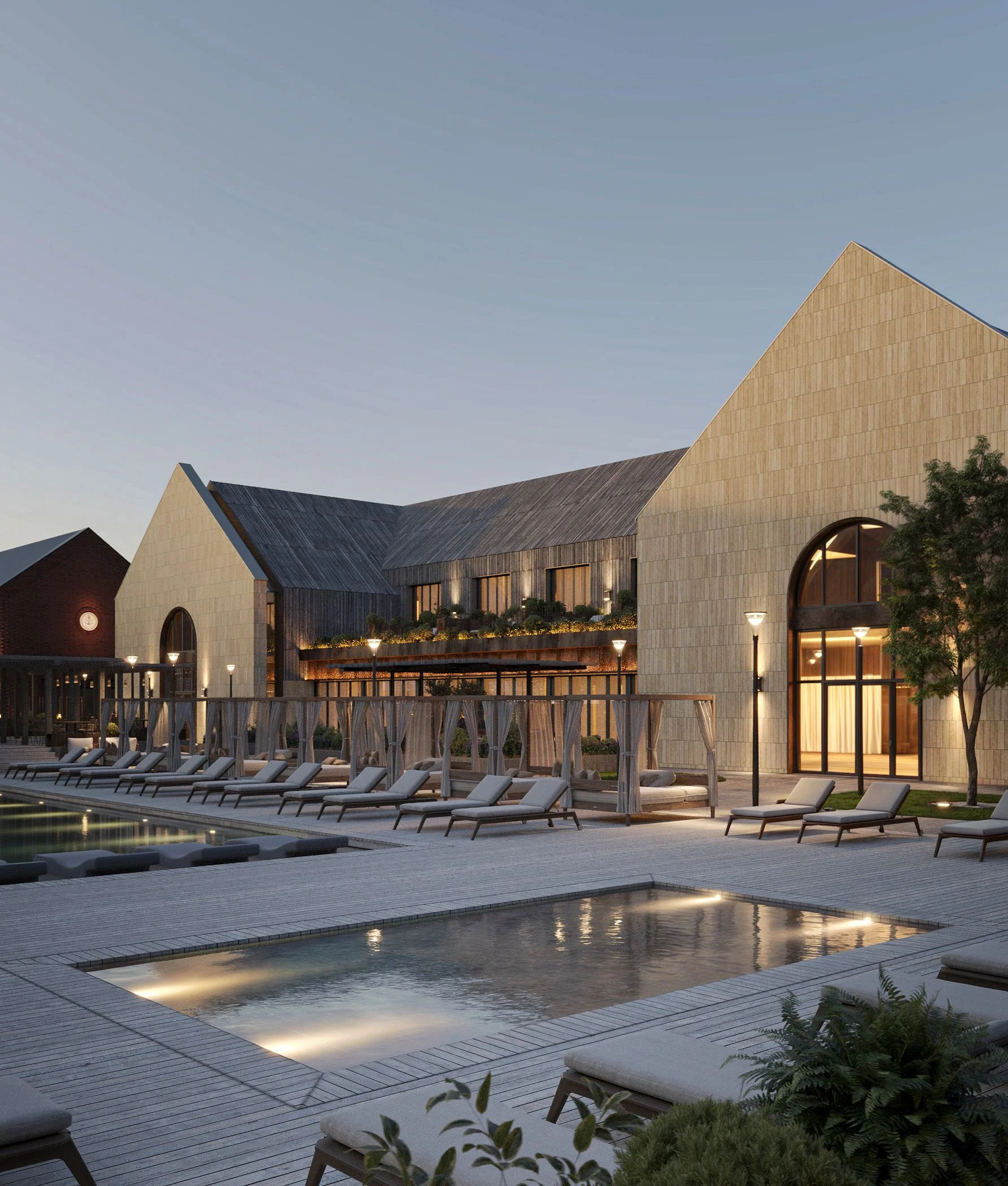 Panoramic view of the courtyard pool surrounded by gable-roofed stone buildings